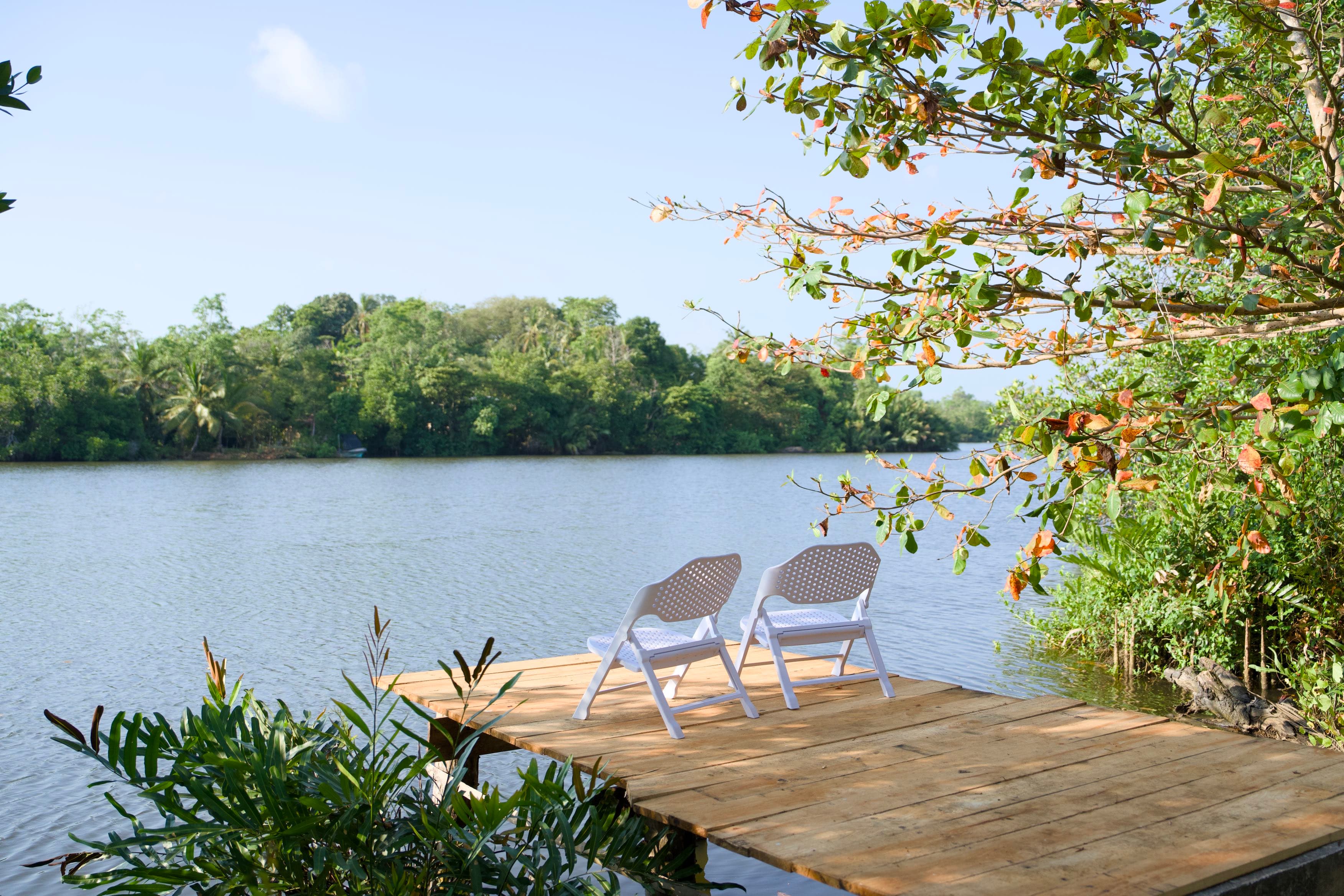 Riverside outdoor deck with tropical garden views at Blended Villas Bentota